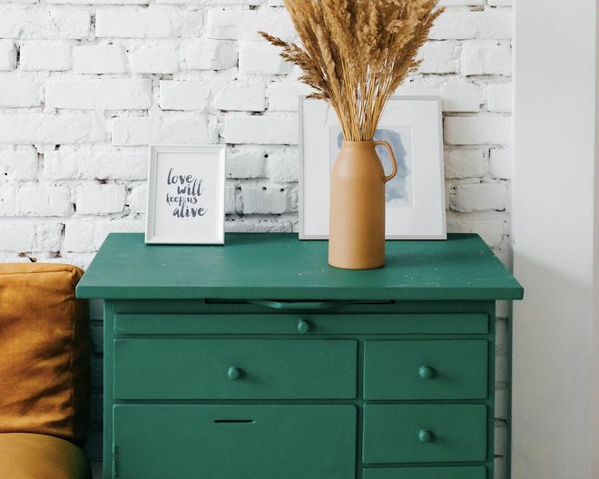 Green drawers with decorative items on top